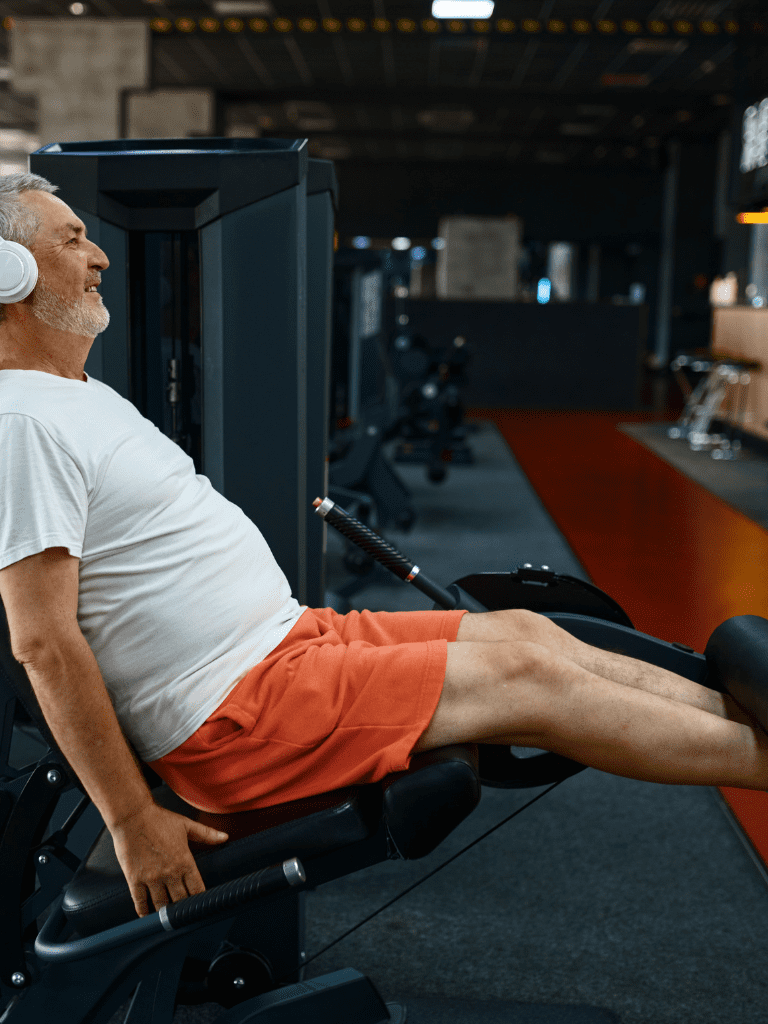 Man using strength training gym equipment to target legs and core to improve strength and stability. 